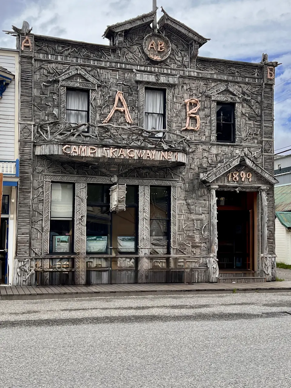 The Arctic Brotherhood Hall features a weathered driftwood-covered facade with an "A B" emblem and a "Camp Skagway No. 1" sign.